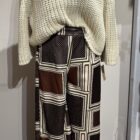 Pantalón palazzo estampado chocolate combinado con jersey de punto crudo, look de otoño.